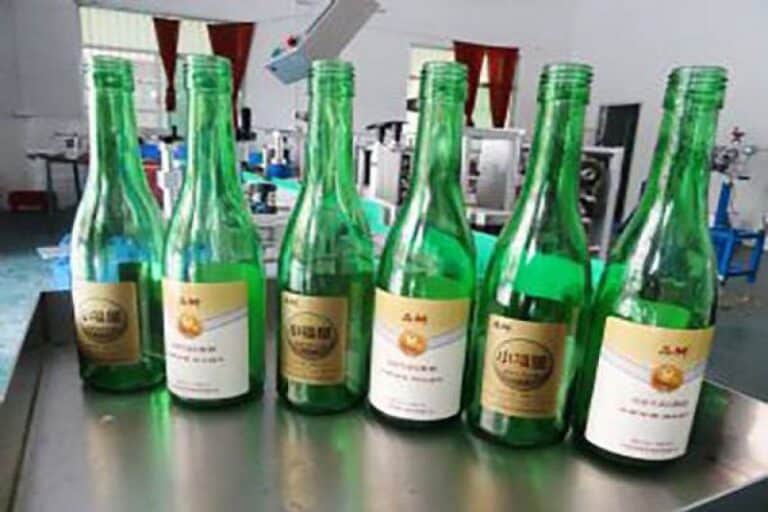 Labeled beer bottles with automatic labeling machine applied for beverage and brewery packaging production line