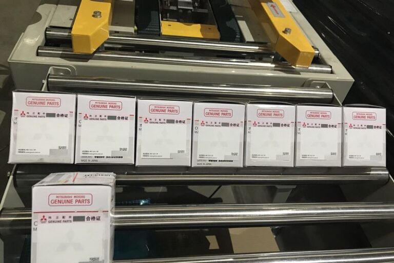 Labeled cardboard box with automatic labeling machine applied for packaging and logistics operations