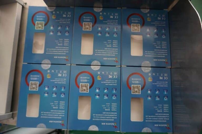 Labeled cardboard box with automatic labeling machine applied for packaging and logistics industry
