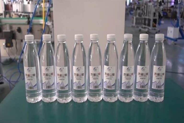 Labeled water bottles with automatic labeling machine applied for bottled water production and beverage packaging line