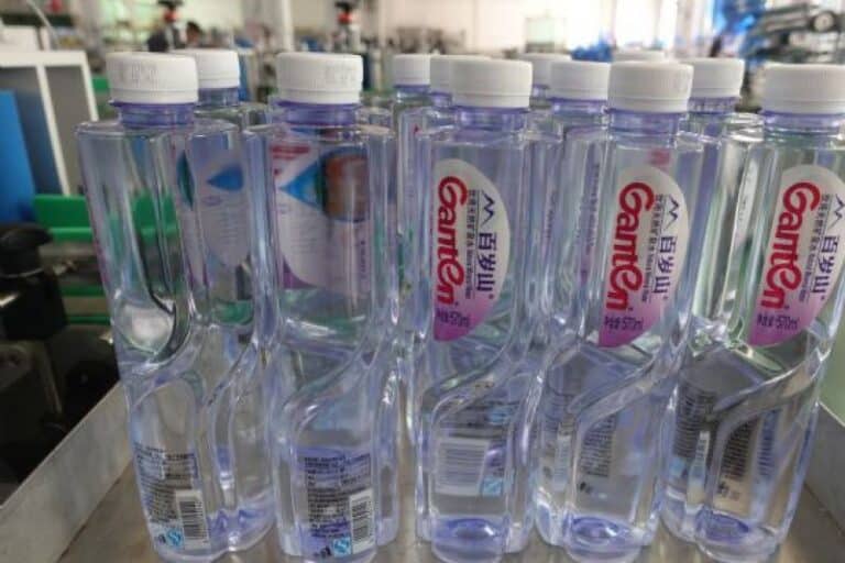 Labeled Ganten water bottles with automatic labeling machine applied for premium bottled water production line