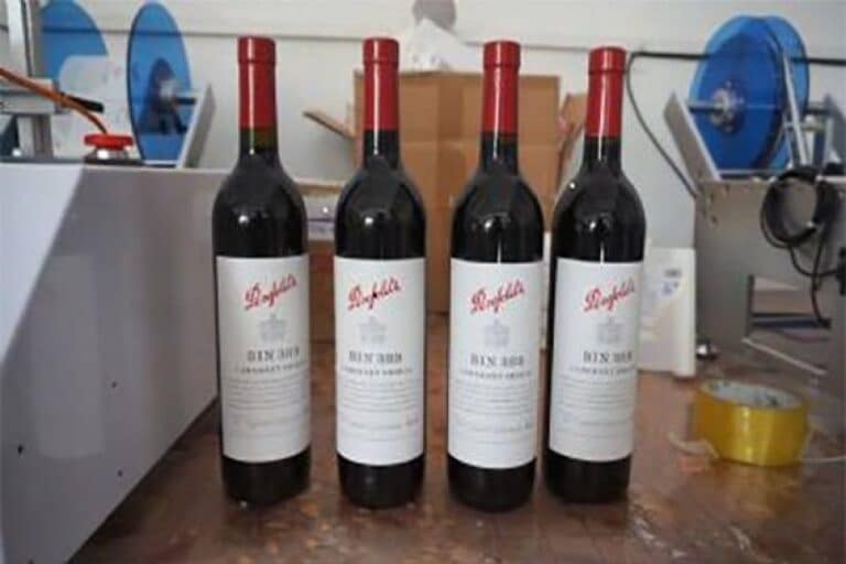Labeled wine bottles with automatic labeling machine for beverage packaging