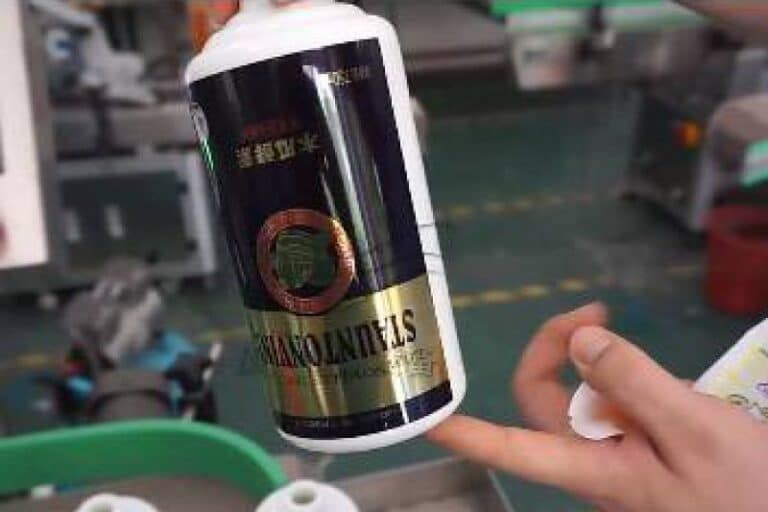 Labeled liquor cans with automatic labeling machine for beverage packaging line