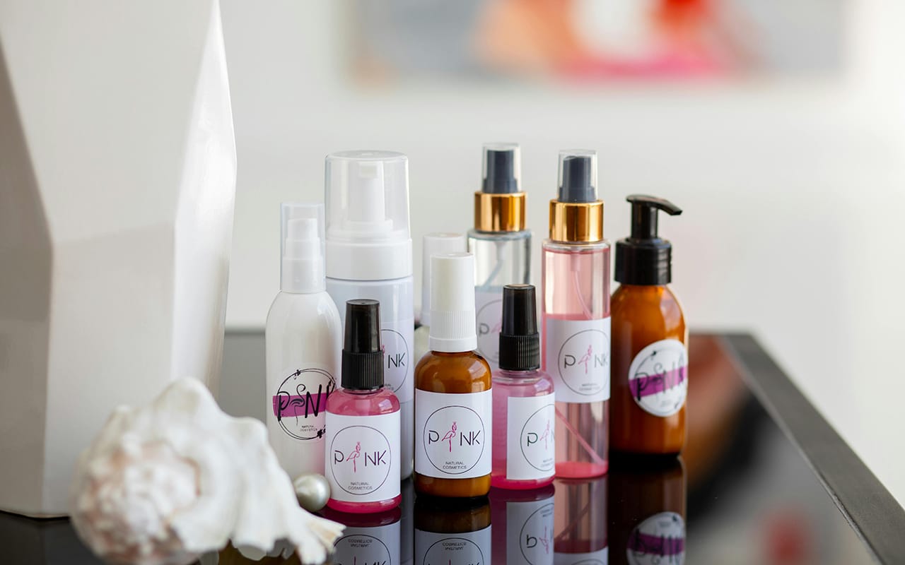 Labeled skincare product bottles with cosmetic packaging labels applied by automatic labeling machine