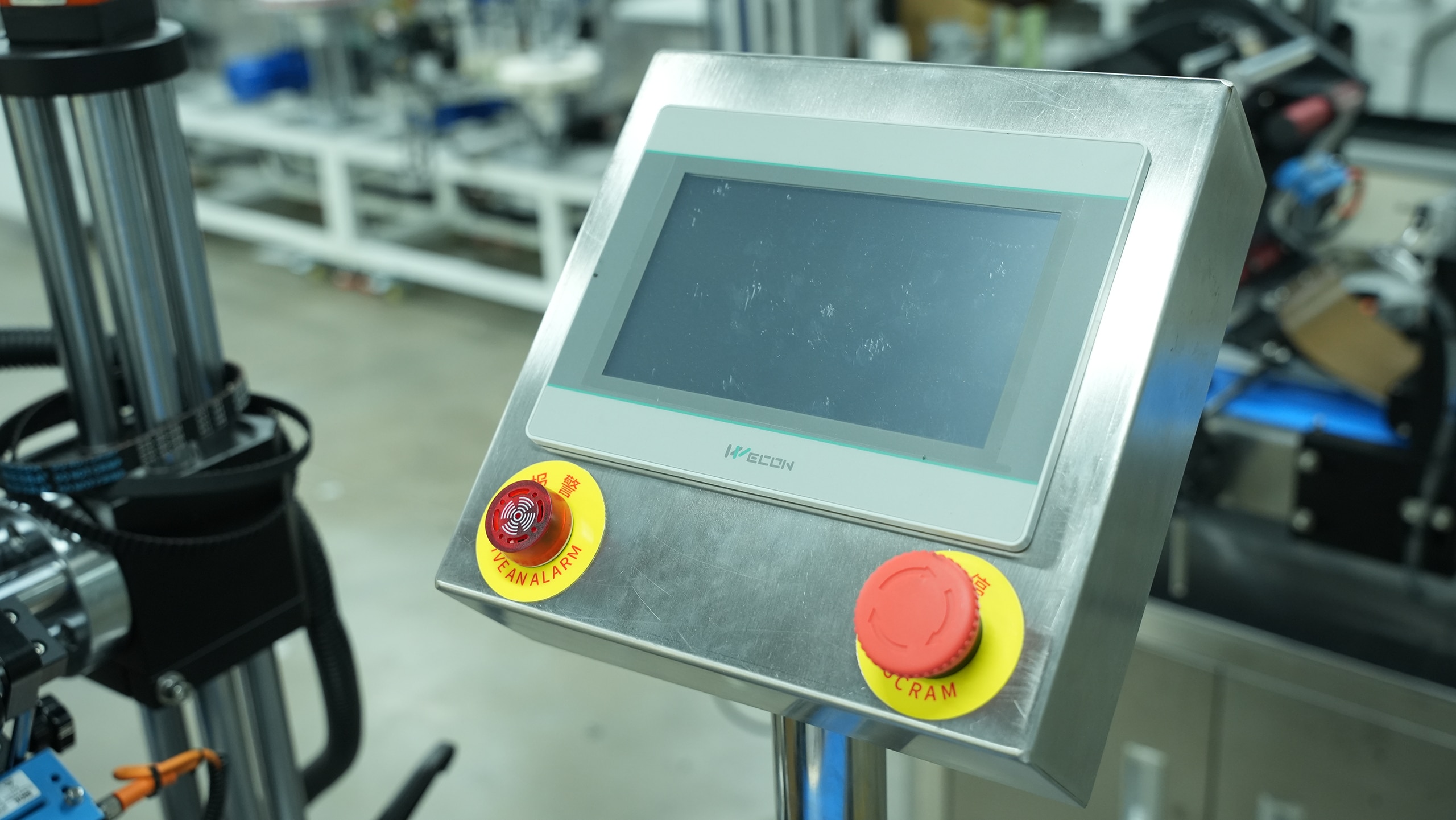 HMI control panel with emergency stop button on an automatic wrap-around labeller