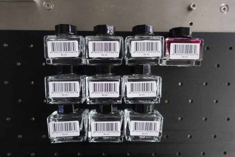 Square ink bottle with a wrap-around self-adhesive label