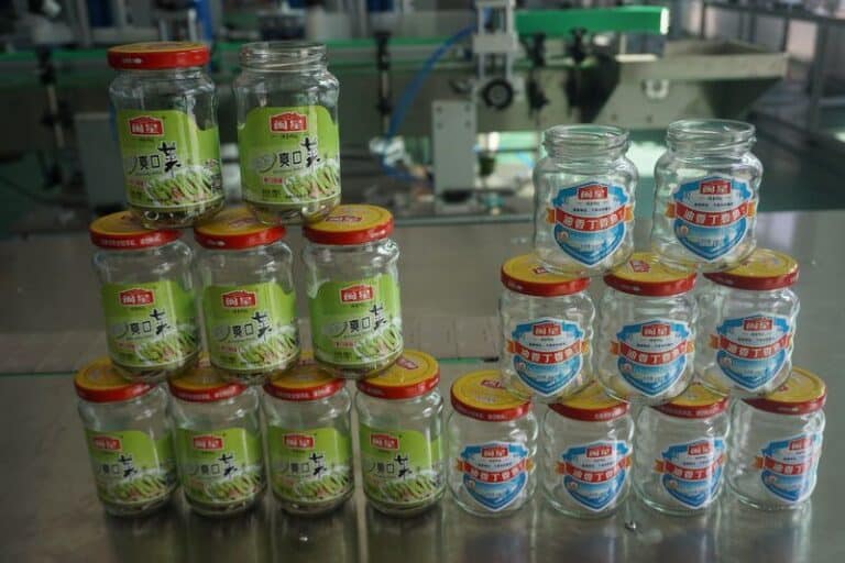 Labeled hexagonal sauce cans with wrap-around self-adhesive labels